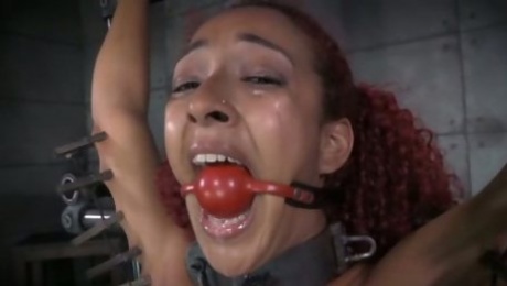 Slender moaning and titless ebony redhead gets fucked with some toys